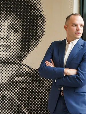 Ryan Moran (he/him) pictured with Elizabeth Taylor, prominent actress, HIV/AIDS activist, and generous supporter of Whitman-Walker's work throughout its history.